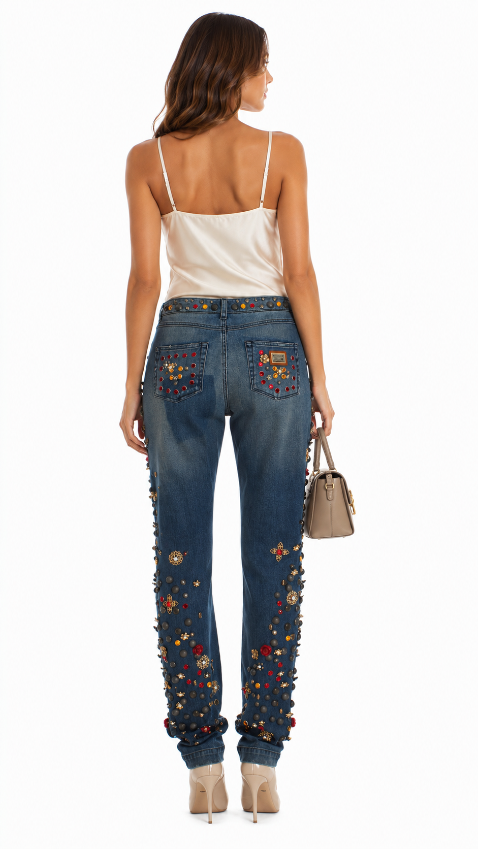 Woman wearing blue jeans with floral embroidery on a white background